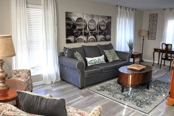 a living room with a gray couch and a coffee table